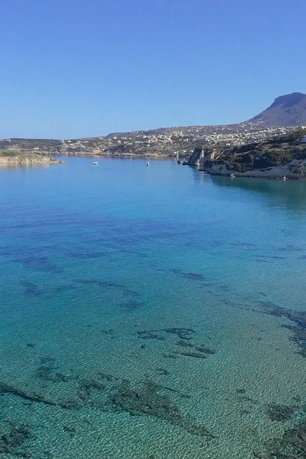 Golden sand and turquoise waters meeting the gentle shore at Kera beach, Crete.